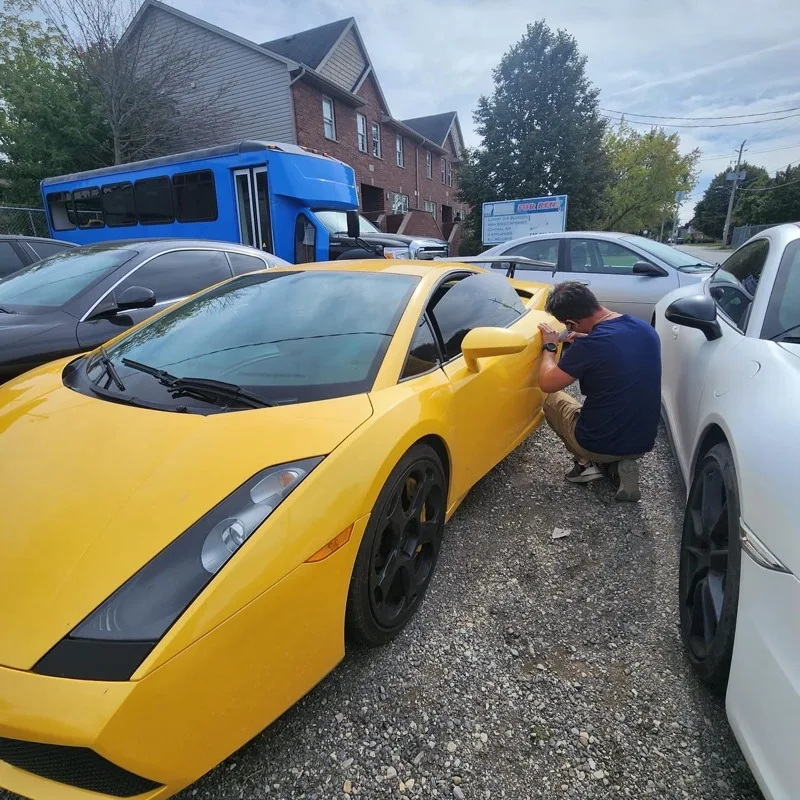 Yellow Lamborghini Gallardo being opened on site during a lockout call